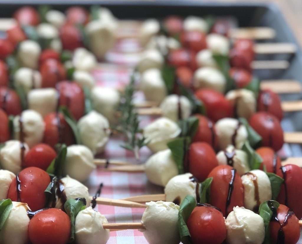 Delicious basil, cherry tomato and bocconcini skewers drizzled with balsamic vinegar - finger food from the Classic Catering range